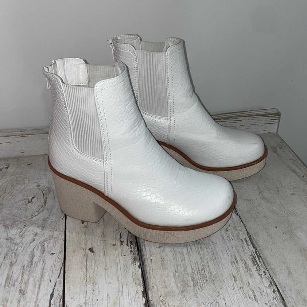White platform booties with orange around the bottom